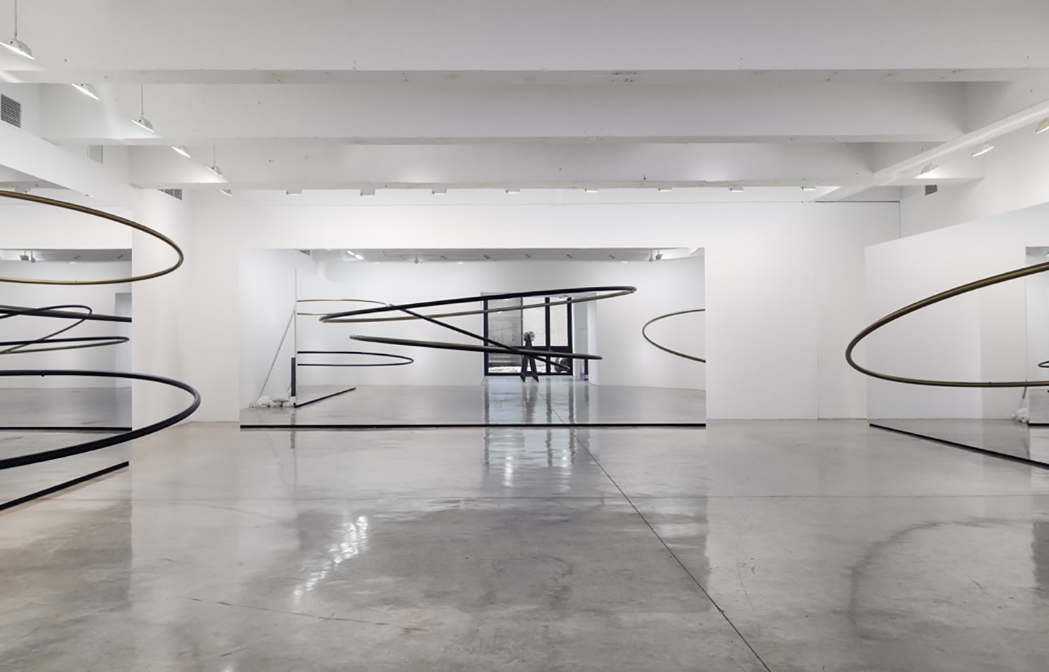 Image of Eliasson, mirrored panels reflecting circular sculptures