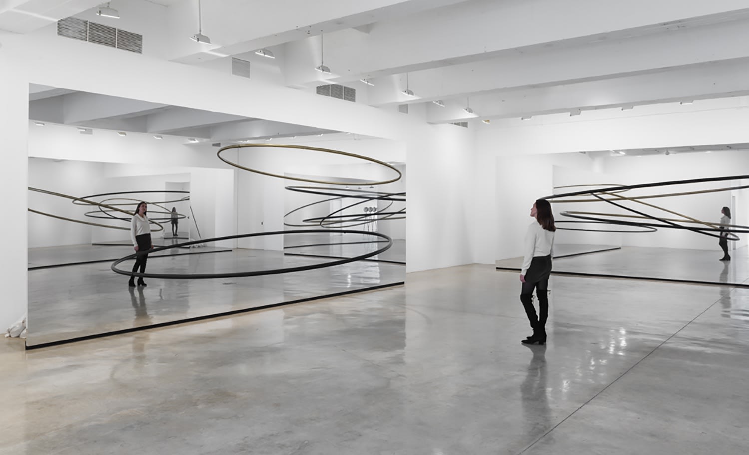Image of Eliasson, mirrored panels reflecting circular sculptures