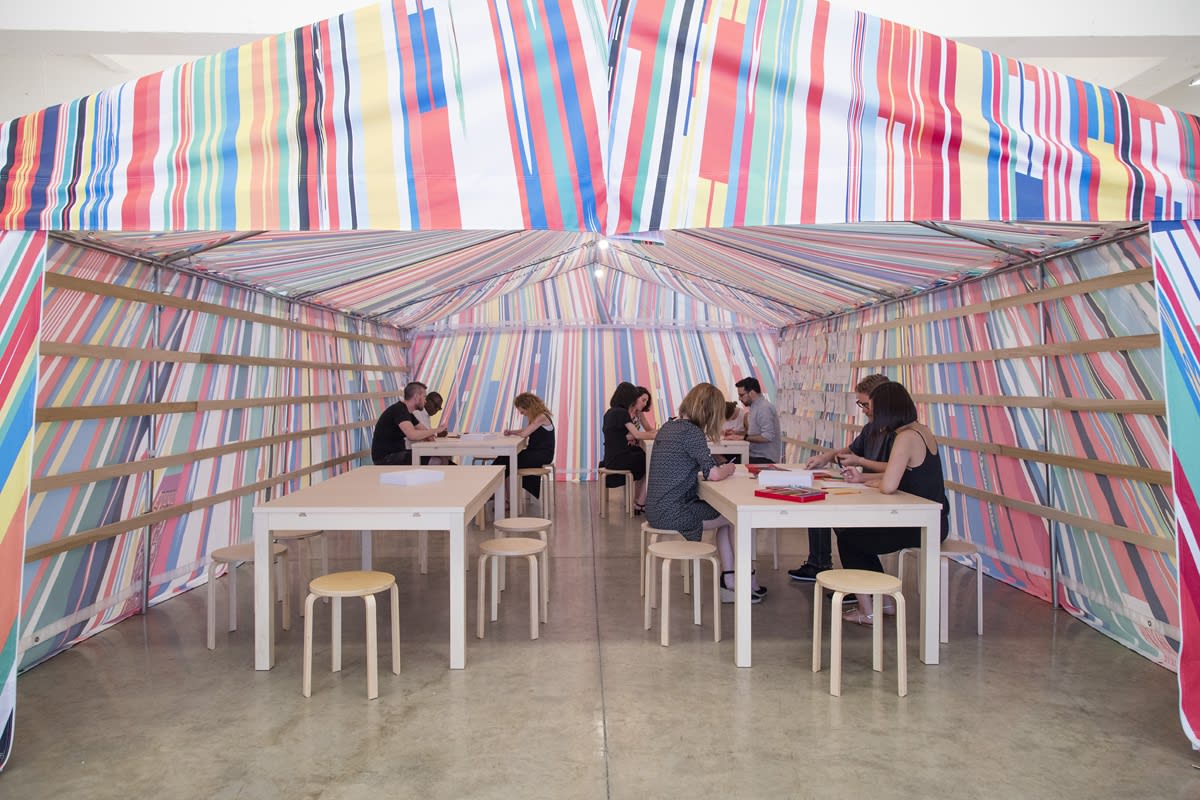 image of a Meschac Gaba tent with tables and drawing material inside