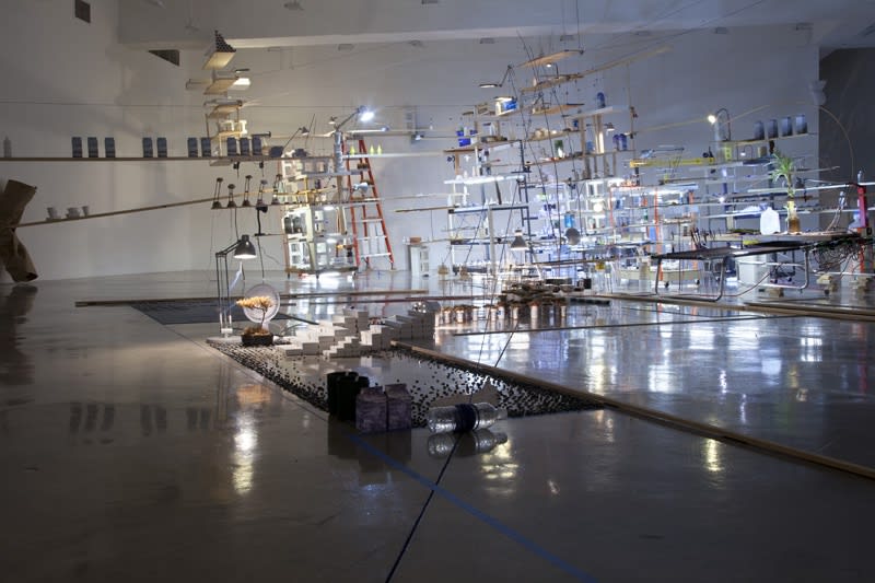 sarah sze installation view of large structure with dimmed lights
