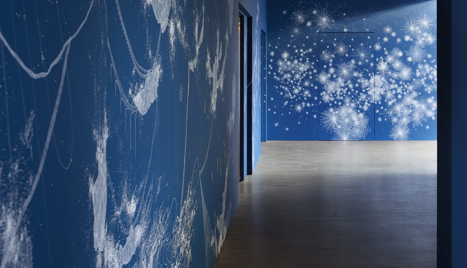 Installation view of blue mural and paintings