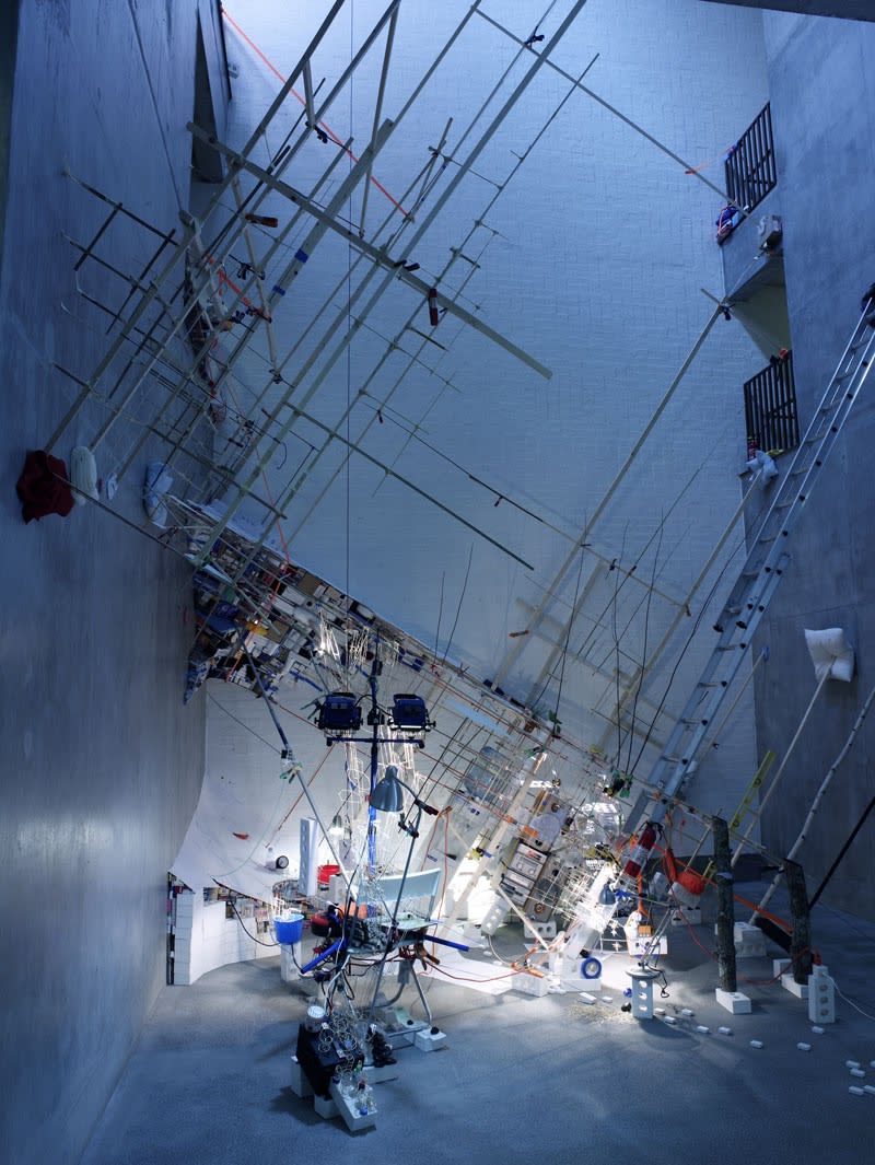 Image of a multi-story installation with ladders and objects