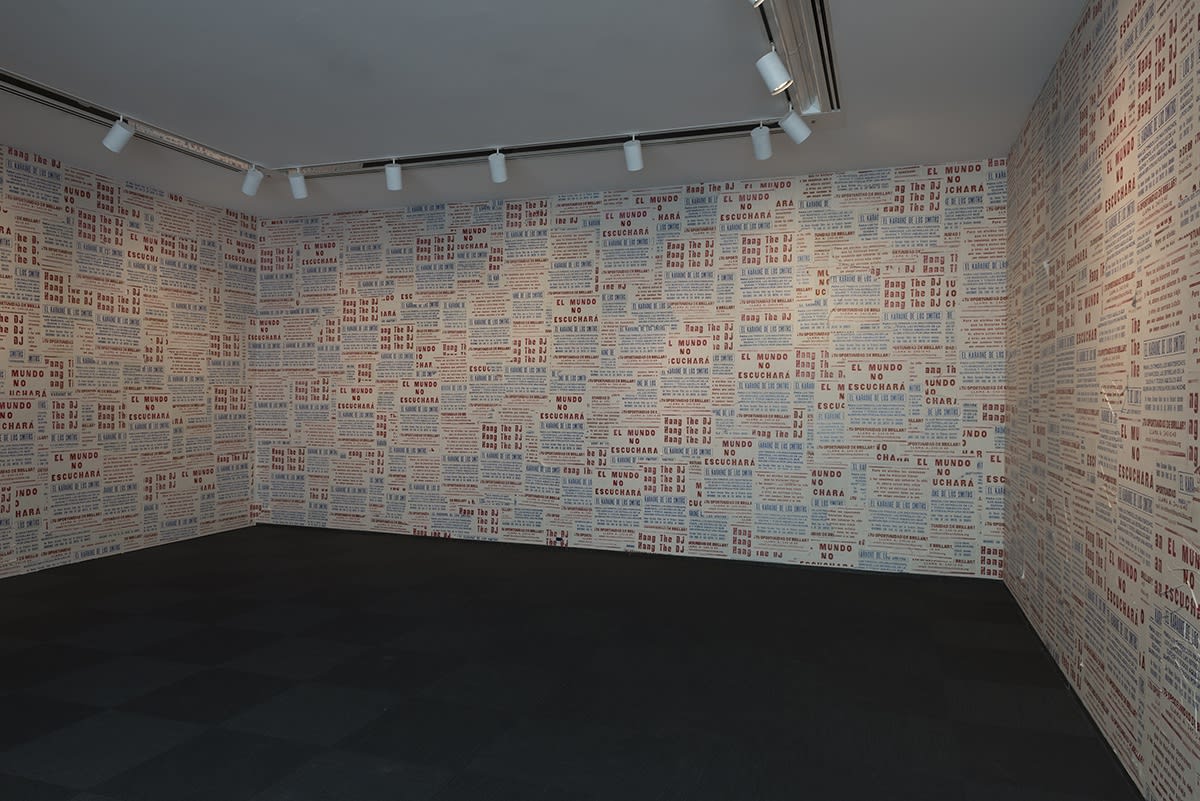 Image of entrance to Phil Collins work at MCA Chicago, walls covered in posters