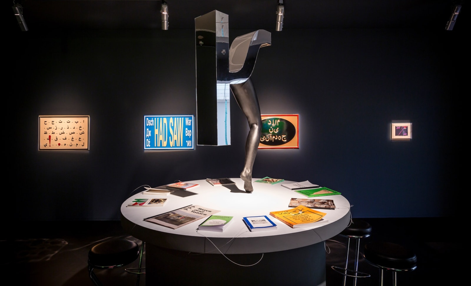 Image of installation view of Slavs and Tatars, table and vacuum wall works