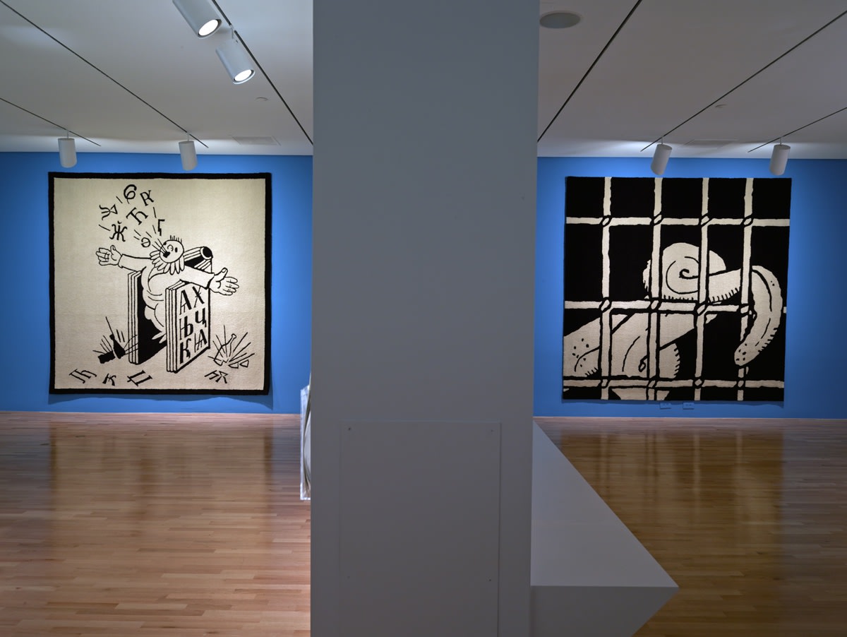 Installation view of Slavs and Tatars at DMA, carpets hanging on blue walls