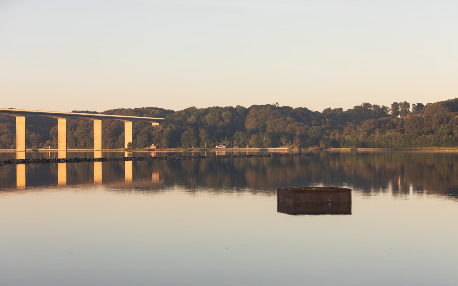 image of a crate floating in the river with fake fruit inside