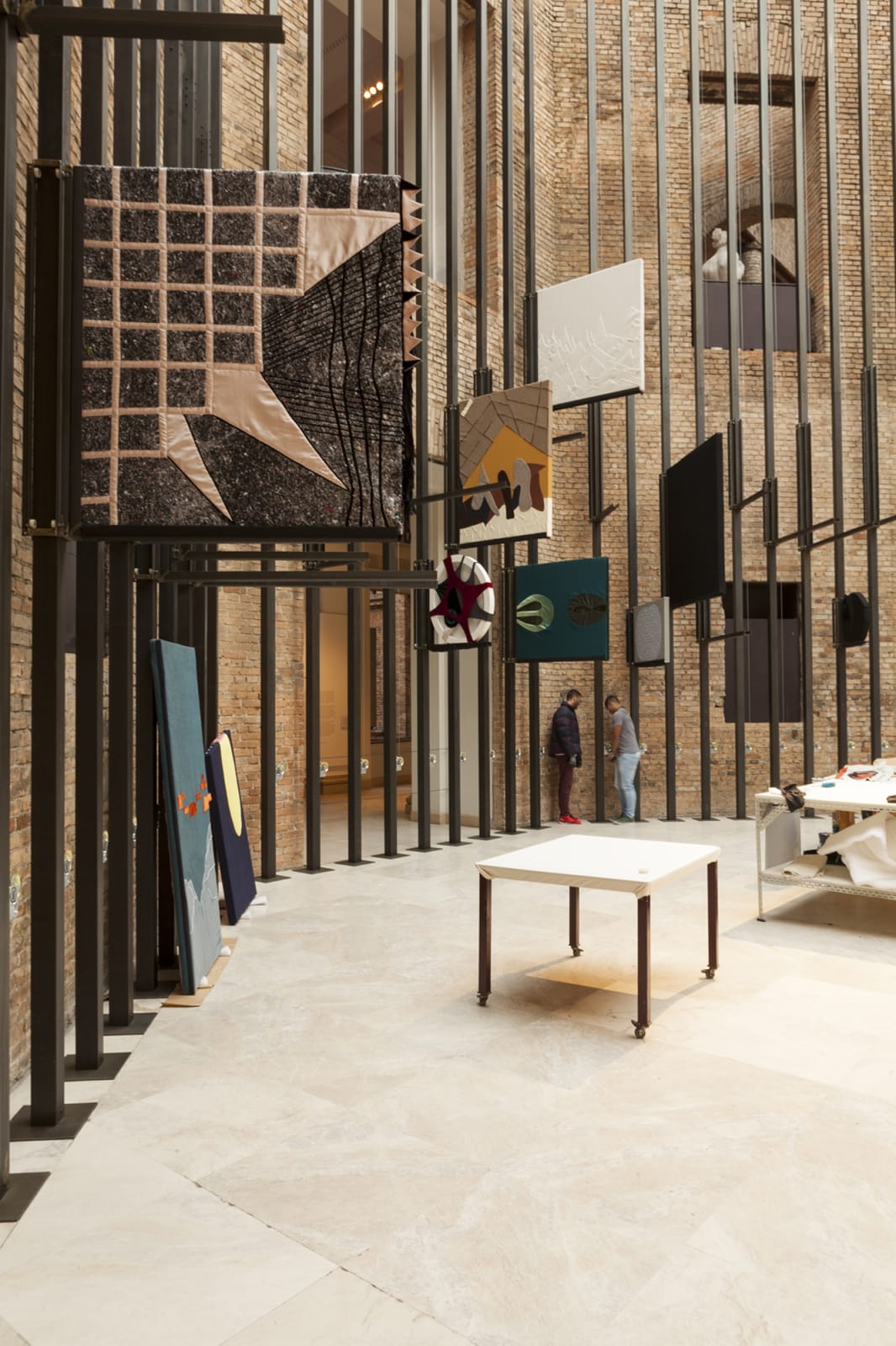 image of tailors sewing / working in a tailor shop set up inside museum