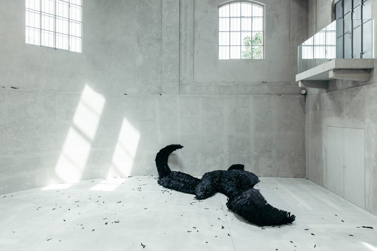 image of a sculpture of a large fallen black bird