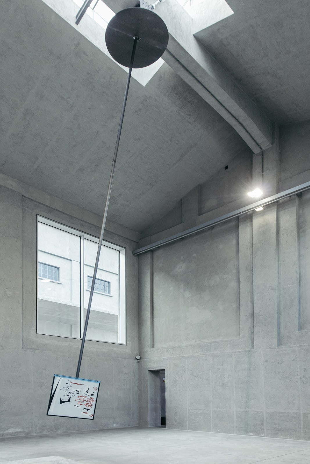 image of a large pendulum with a drawing on it
