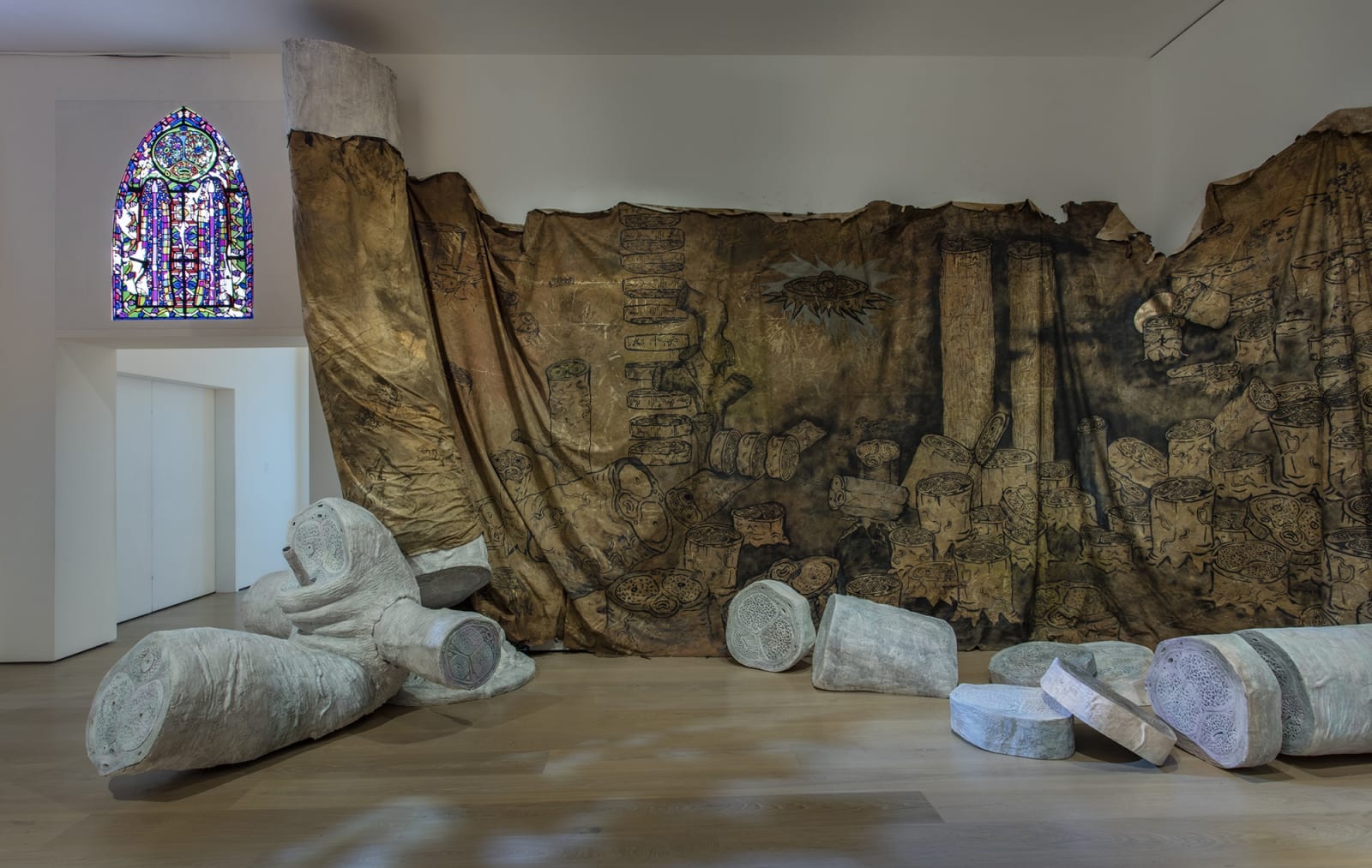image Charles Long sculptural installation in darkened gallery space, large scroll with tree drawings