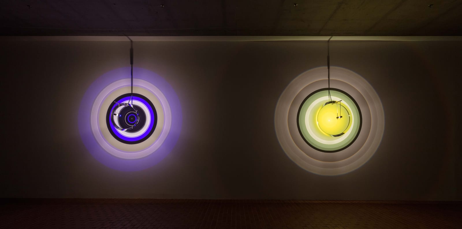 image of lighthouse lense sculptures emitting colorful lights