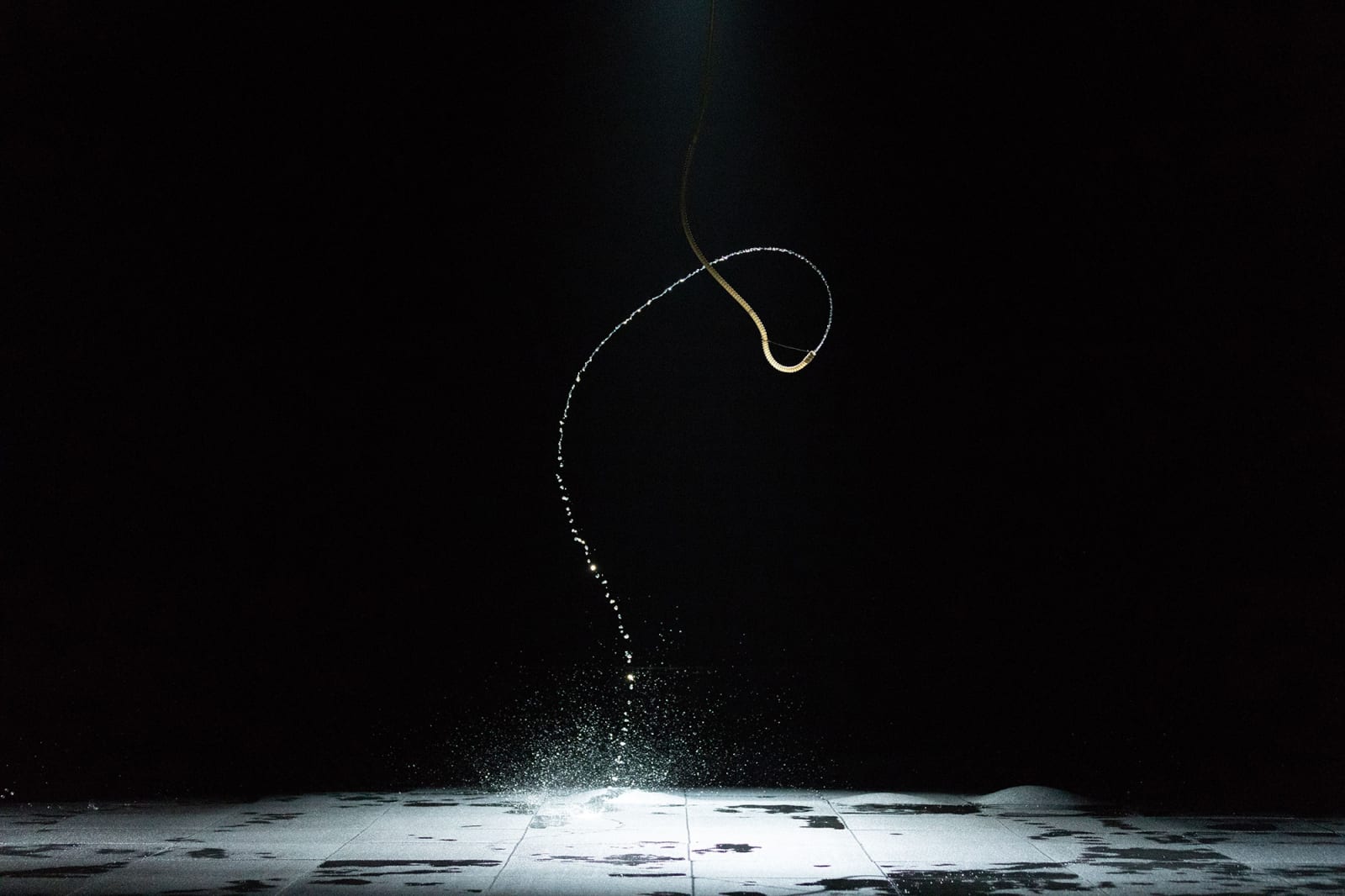 image of a water jet in dark room