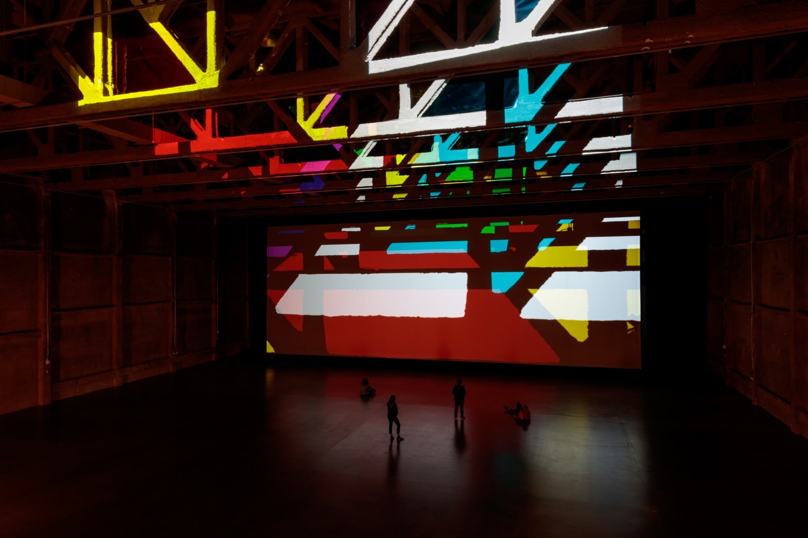 image of installation view large space with color filters and lights projecting onto the wall