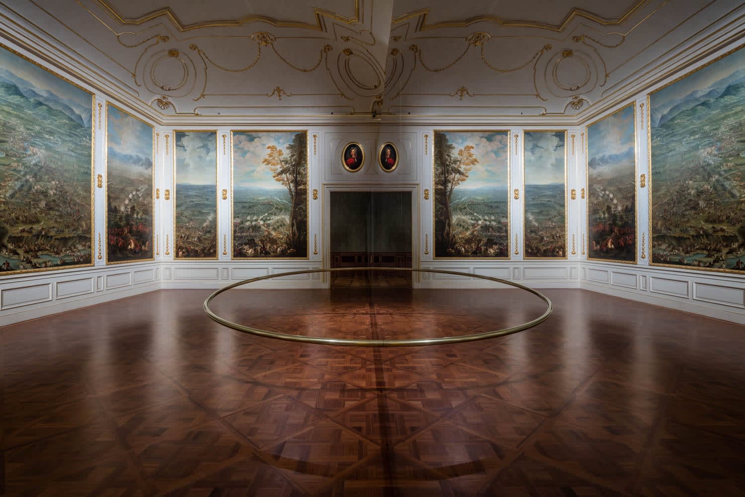 room with circular sculpture in the middle