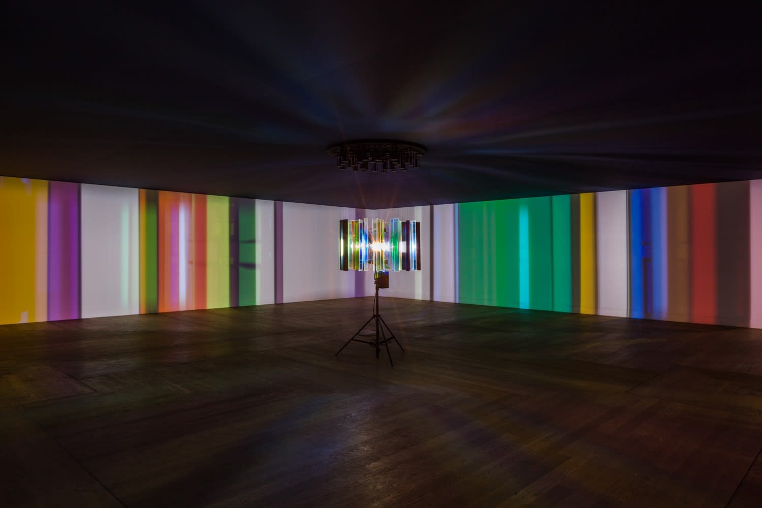 dark room with center light projecting stripes on the walls