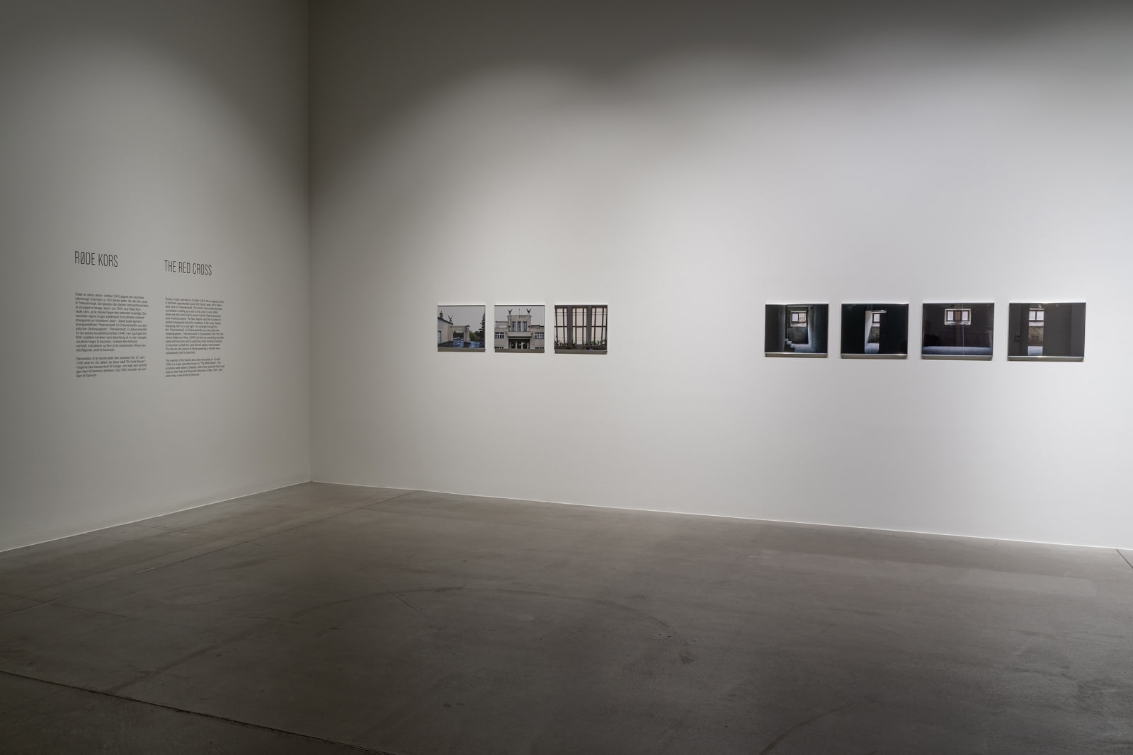 Susan Philipsz's film still image, two channel projection of concrete building facades in dark room