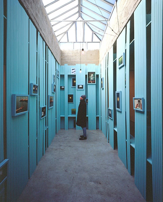 Cinto blue structure under skylight with photographs