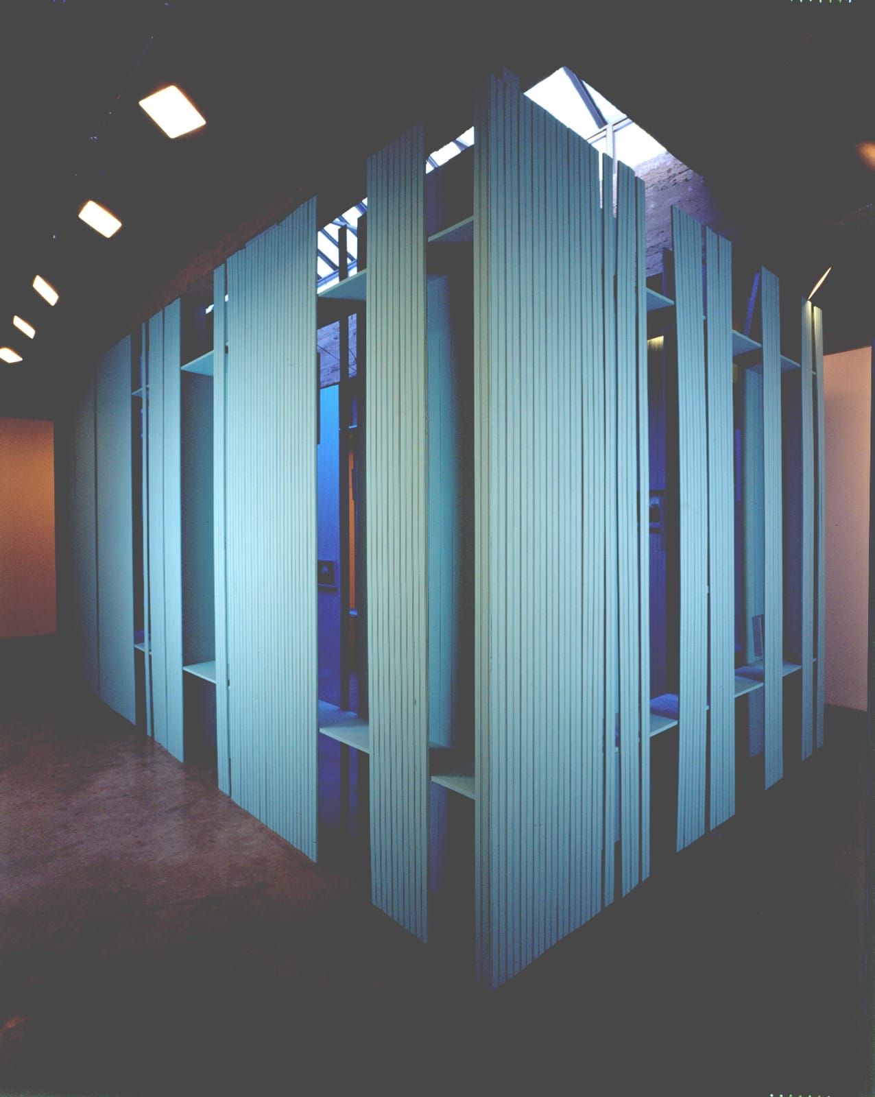 Cinto blue structure under skylight with photographs