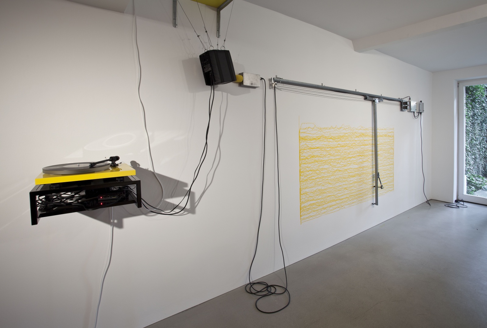 <div class="image_caption_container"><div class="image_caption"><p class="image_caption"><span>Angela Bulloch, </span><span>Short Big Yellow Drawing Machine</span><span>, 2012, Drawing Machine, ink (yellow), wall mounted table, MP3 player or yellow record player, ABCDLP 002 record, pre amp, various cables, Genelec speaker, sound piece "Short Big Drama for YDM" by George van Dam, dimensions variable, Collection of the National Gallery of Victoria, Melbourne. Photo © Andrea Rossetti</span></p></div></div>
