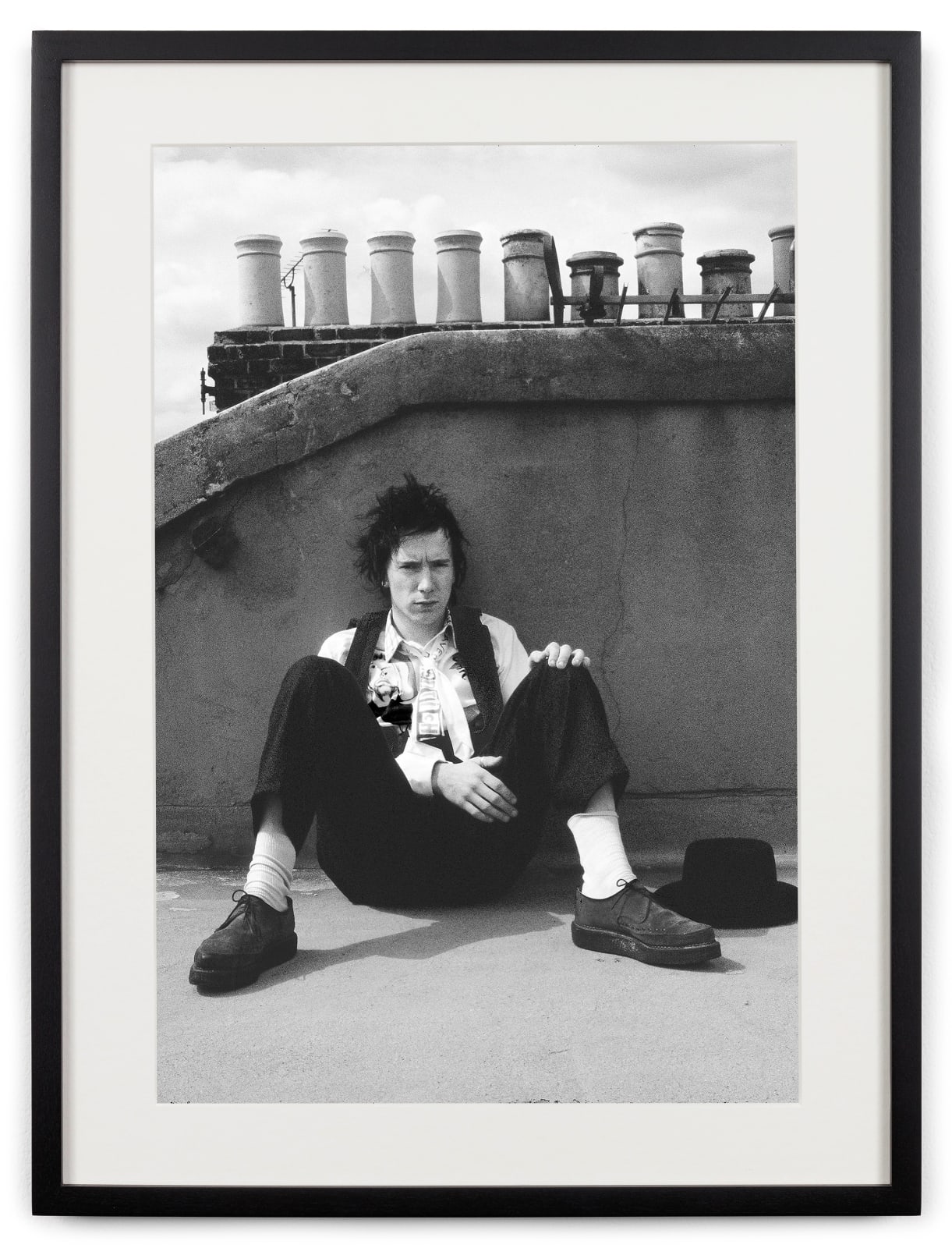 <div class="artist">Caroline Coon</div><div class="title_and_year"><span class="title">Johnny Rotten on his roof of his home, taking a break from recording tracks for his post-Sex Pistols band, Public Image Ltd (PIL). Warwick Road</span><span class="year">, 1978</span></div>