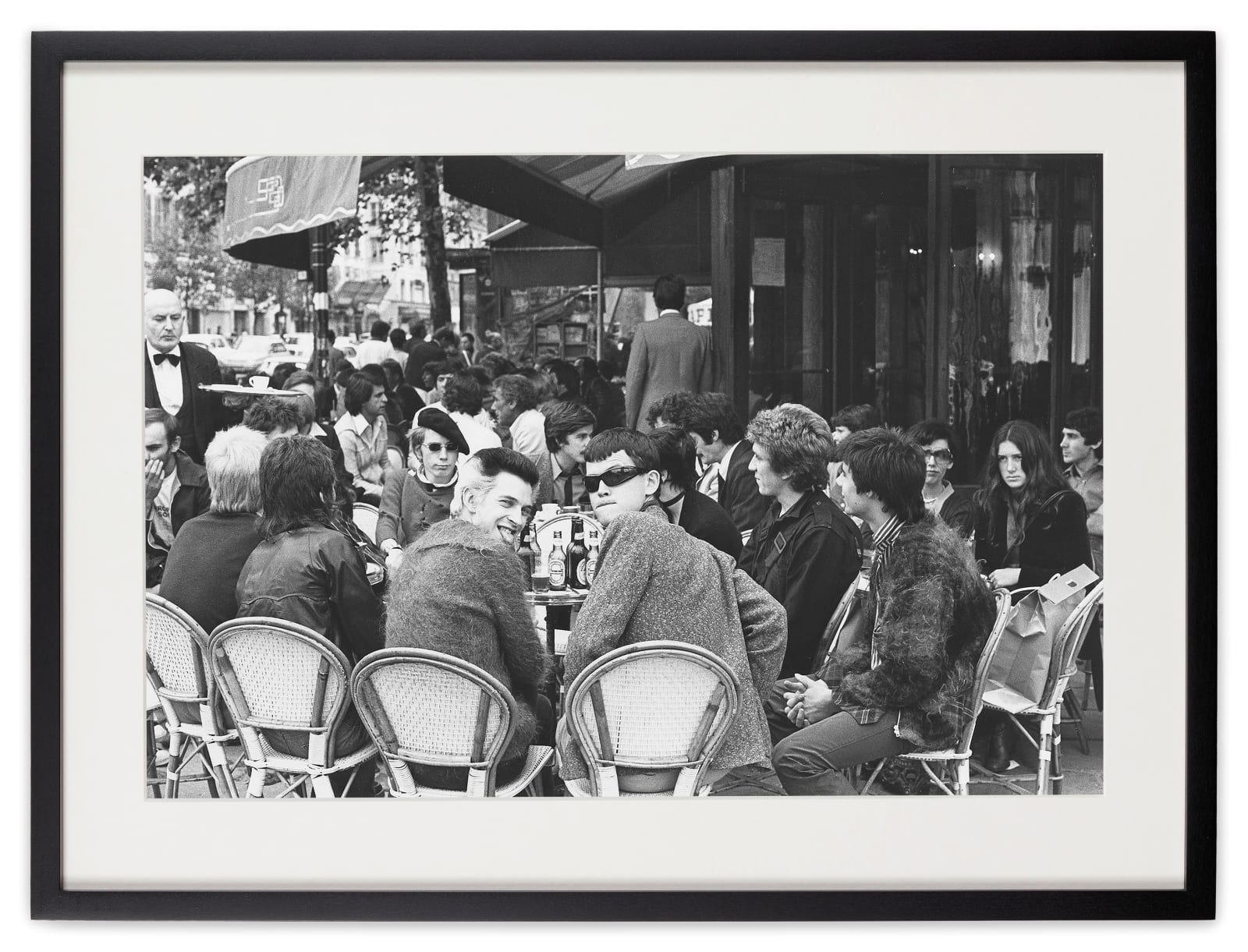 <div class="artist">Caroline Coon</div><div class="title_and_year"><span class="title">The Sex Pistols - Paul Cook, Johnny ‘Rotten’ Lydon, Steve Jones and Glen Matlock – and photographer Ray Stevenson meet up with the band’s fans - Siouxsie Sioux, soon to be on stage with Steve Havoc as Siouxsie and the Banshees and Billy, soon to be Bill</span><span class="year">, 1976</span></div>