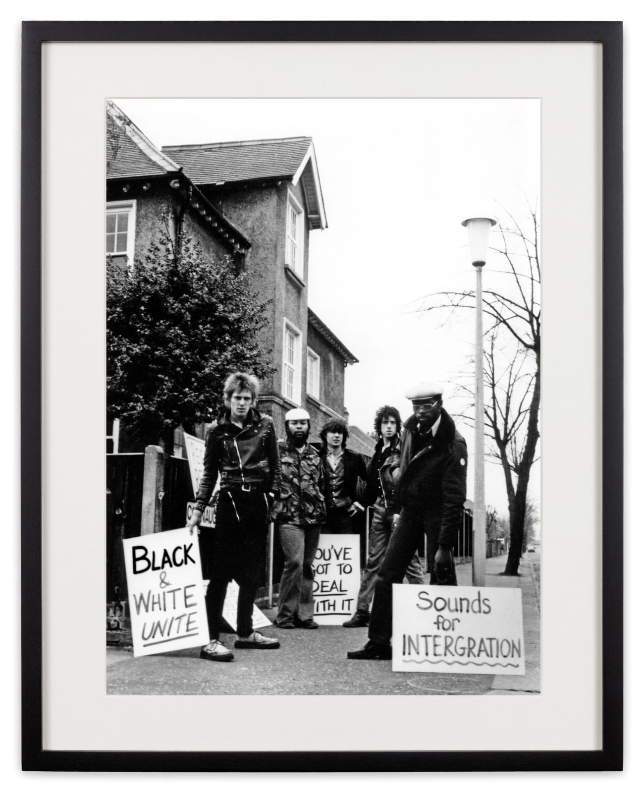 <div class="artist">Caroline Coon</div><div class="title_and_year"><span class="title">The Clash, The Sex Pistols and Steel Pulse demonstrate outside leader of the neo-fascist National Front’s headquarters on Connaught Road, Teddington. Passing local residents look on</span><span class="year">, 1978</span></div>