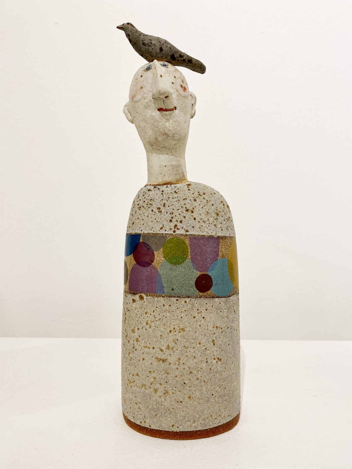 Jane Muir figurative sculpture of a man with a bird on his head