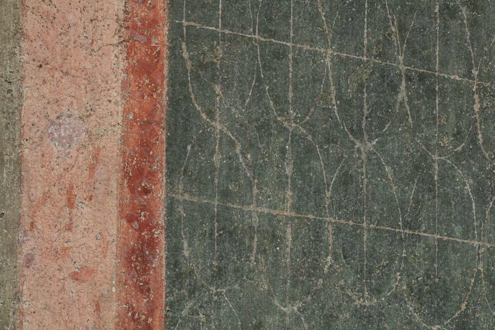Detail of a ripped fresco of the Virgin Mary in Majesty holding Jesus Christ. This detail shows the patterned edge of the architecture framing the two figures.