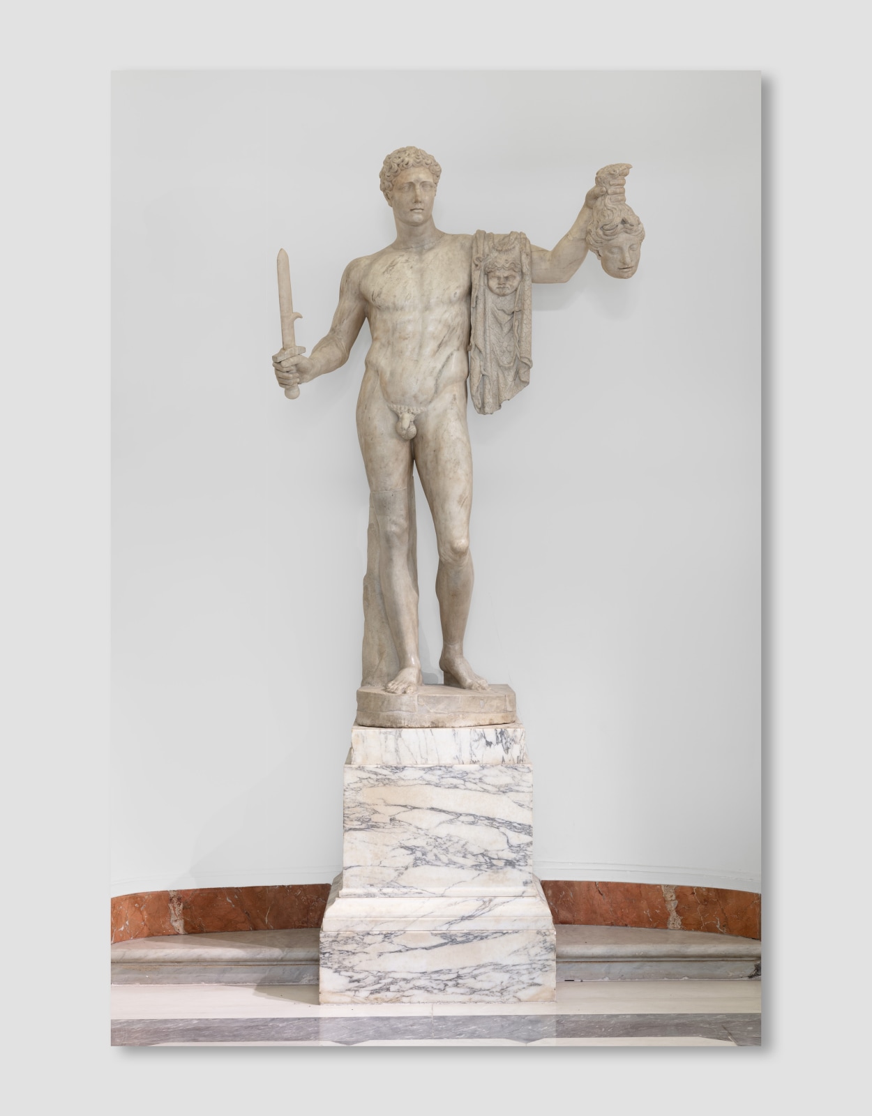 A Pentelic marble sculpture depicting the mythological story of Perseus beheading Medusa.