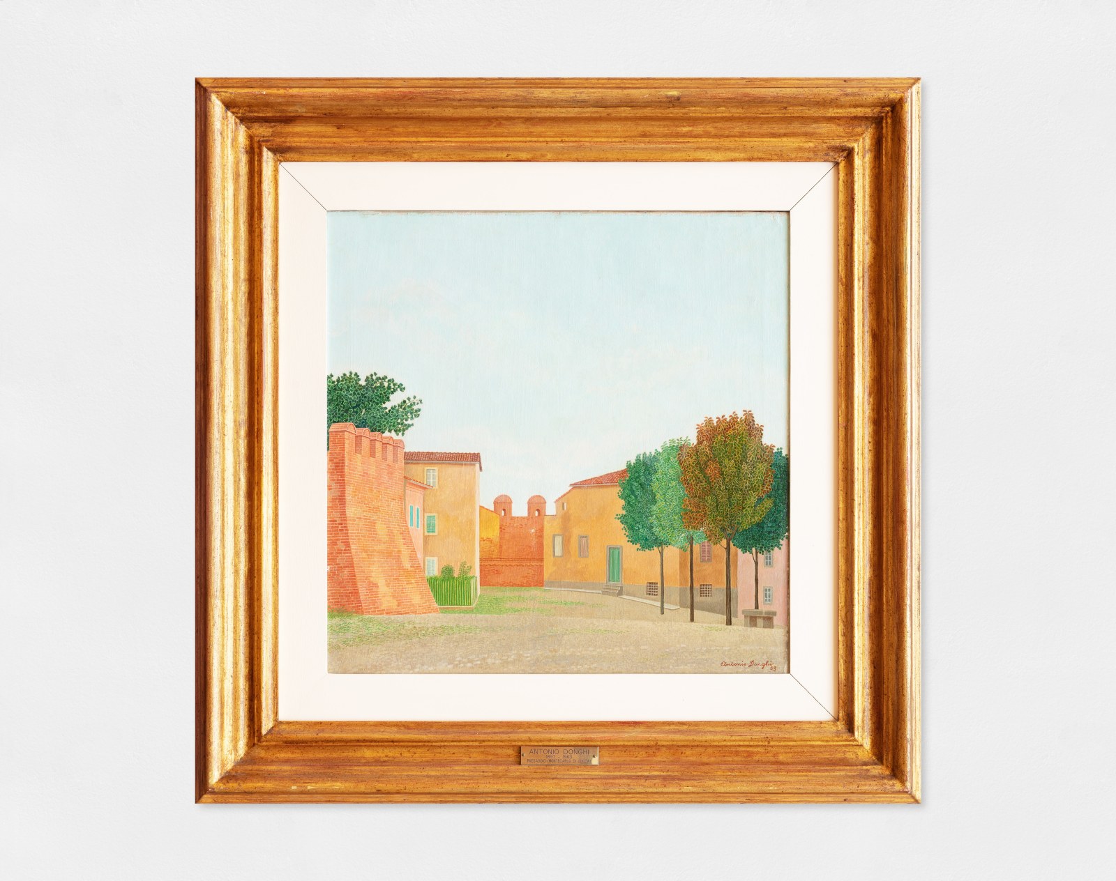 An oil painting of Montecarlo of Lucca showing the castle walls, buildings and trees.