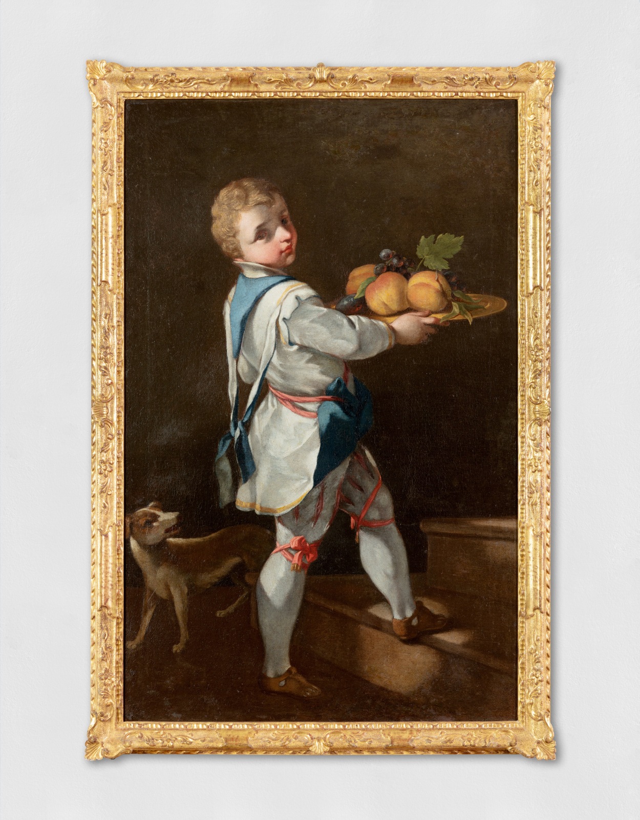 An oil painting of a young boy with a fruit platter.