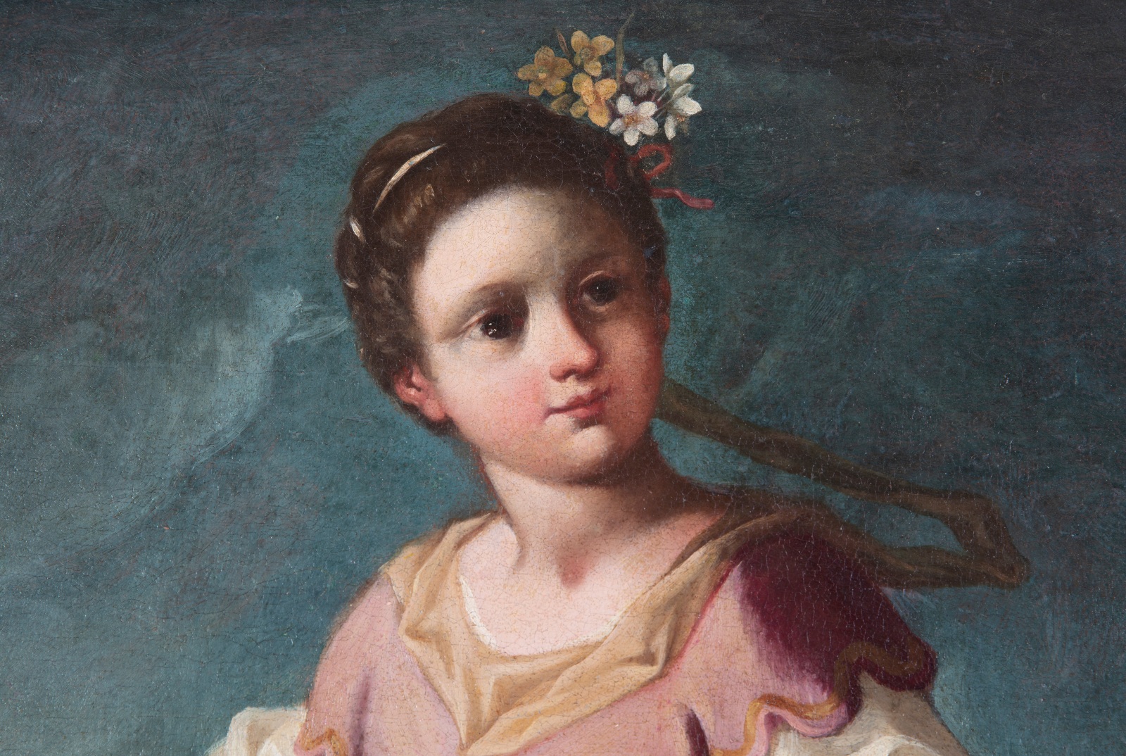 Detail of an oil on canvas painting of a young girl with flowers in her hair and a dark blue background.