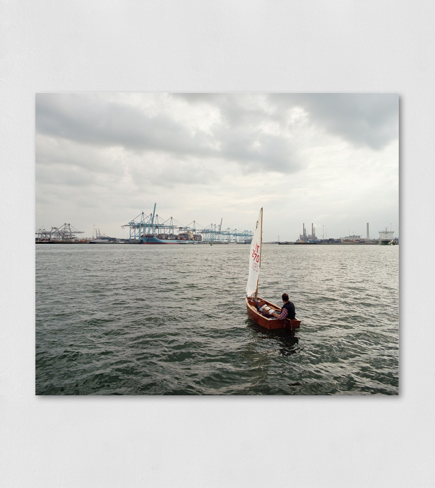 A Lambda photographic print on aluminium of a single boat and sailor in the Europahaven port of Rotterdam.