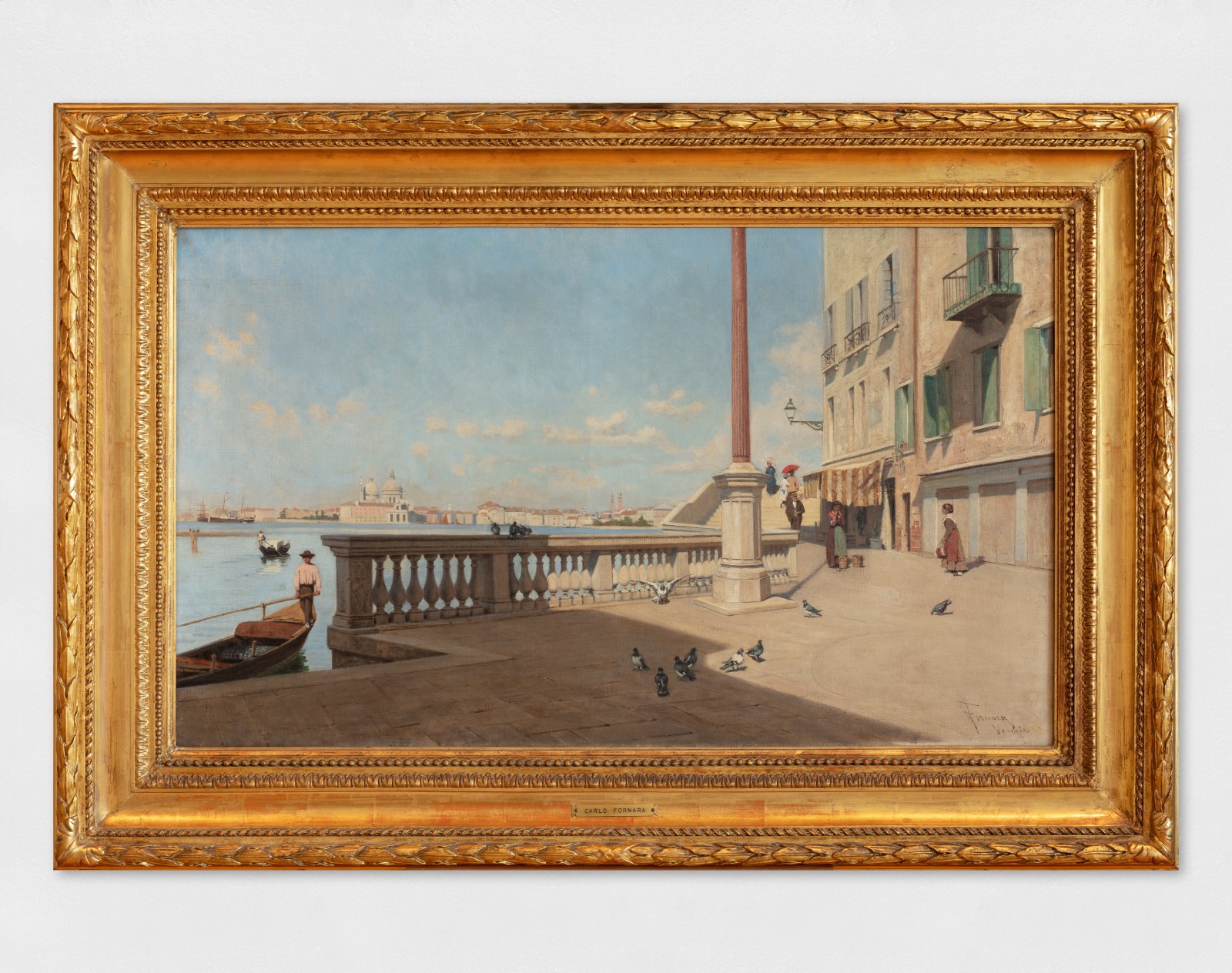 An oil painting depicting a scene of Venice with the lagoon gondolier and pigeons. Artwork details: Artist: Carlo Fornara. Artwork title: Venezia. Artwork date: c.1890-1900. Artwork medium: Oil on canvas. Artwork dimensions: 60 x 100 cm.