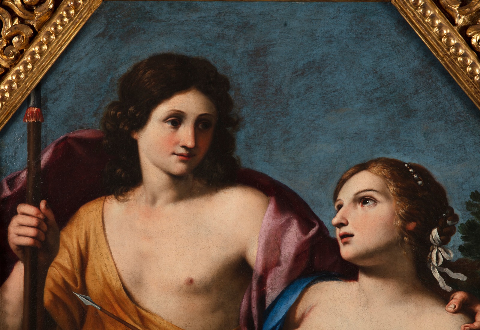 Classical painting with two adults and a child, faces obscured, octagonal golden frame.