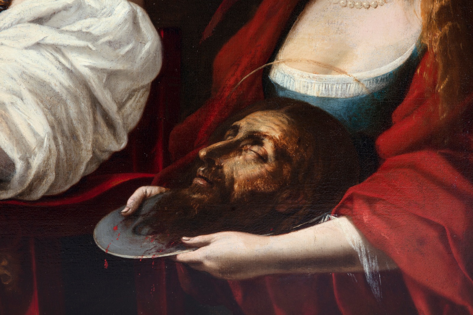 Detail of an oil painting of the biblical event from the New Testament, the story of the beheading of John the Baptist where the severed head is presented on a silver platter to Herod Antipas, ruler of Galilee under the Roman Empire who ordered his execution.