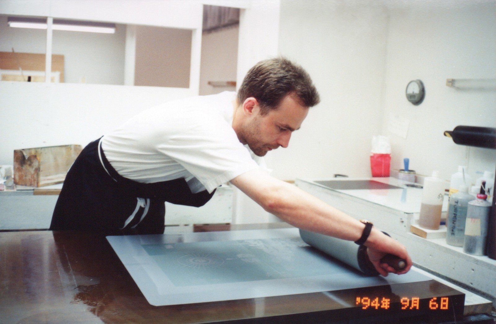 Murray Robertson at a architectsdraughting table sketching in front of a window