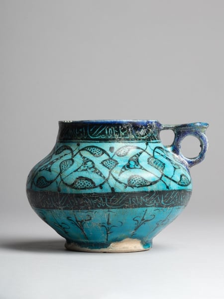 <span class="title"><em>A jug with swirling palmettes and inscriptions under a turquoise glaze, Iran, probably Kashan</em>, c. 1200-1220</span>