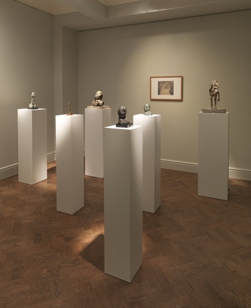 Back Gallery (Left to Right) : Figure on Wheels (1956), Standing Figure (c. 1954), Shattered Head (1956), Small Head (1953), Head (1953), Head (The Early Head) (1953) and Figure with Raised Arm (1955)