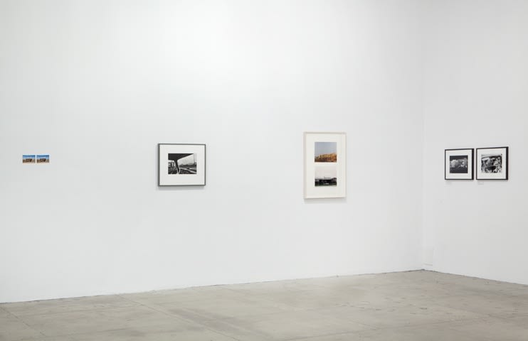 Three photographic diptychs and one photograph are displayed in the corner of a room. 