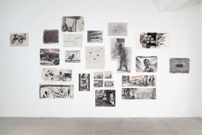 Gallery view of multiple charcoal drawings on paper of varying sizes, depicting landscapes, portraits, and text.
