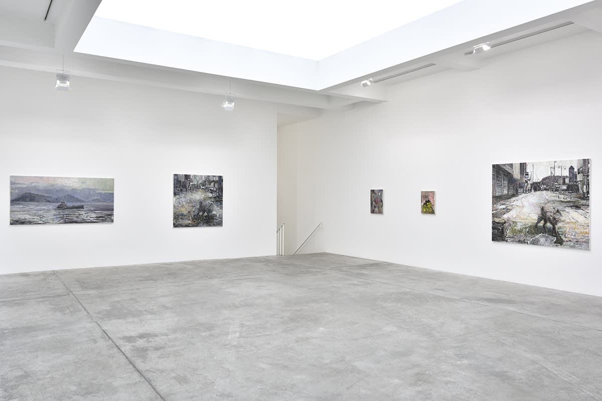 In a large white space, several expressionist oil paintings of various sizes and subjects hang.