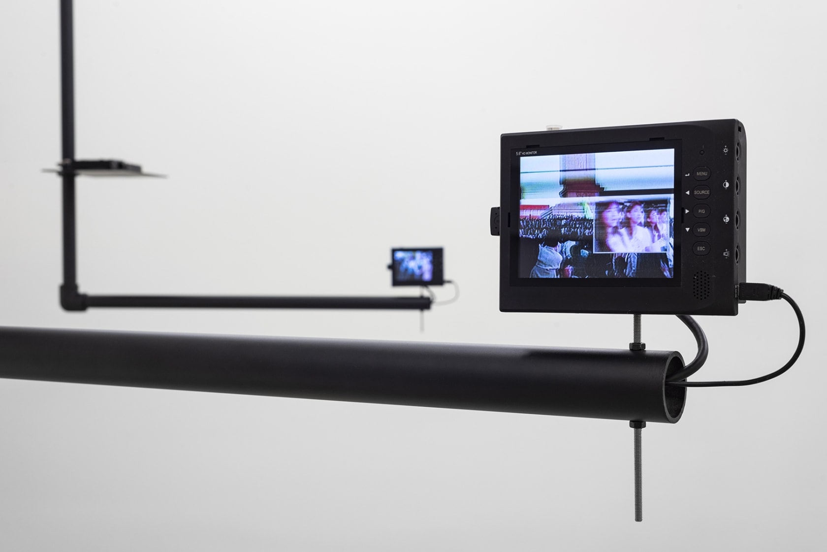 A small screen plays a video with vertical bands displaying an indistinct crowd.