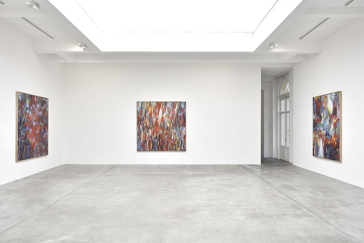 Gallery view of three abstract Sabine Moritz paintings flanking a doorway.