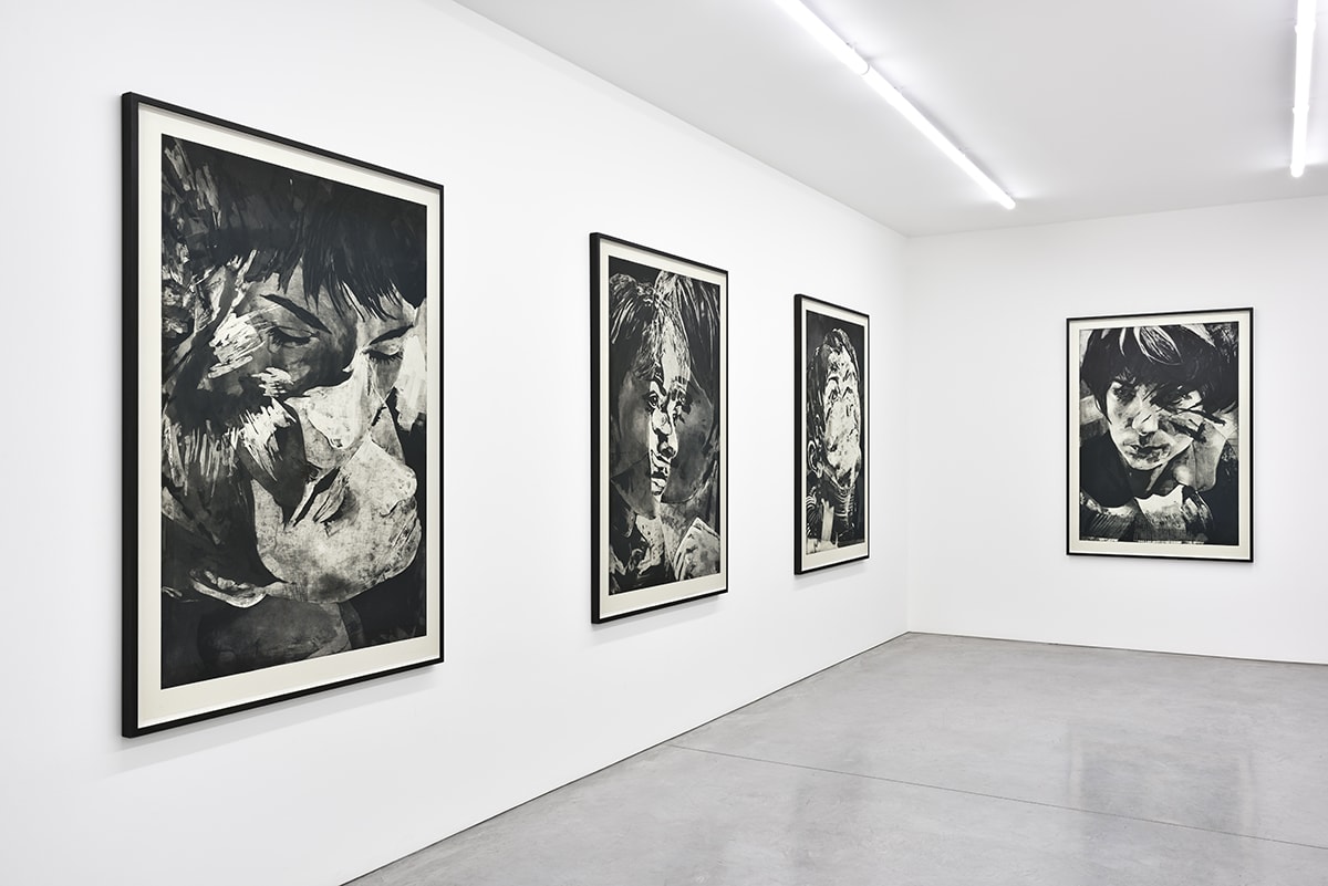 Gallery view of four vertical black and white painted portraits.