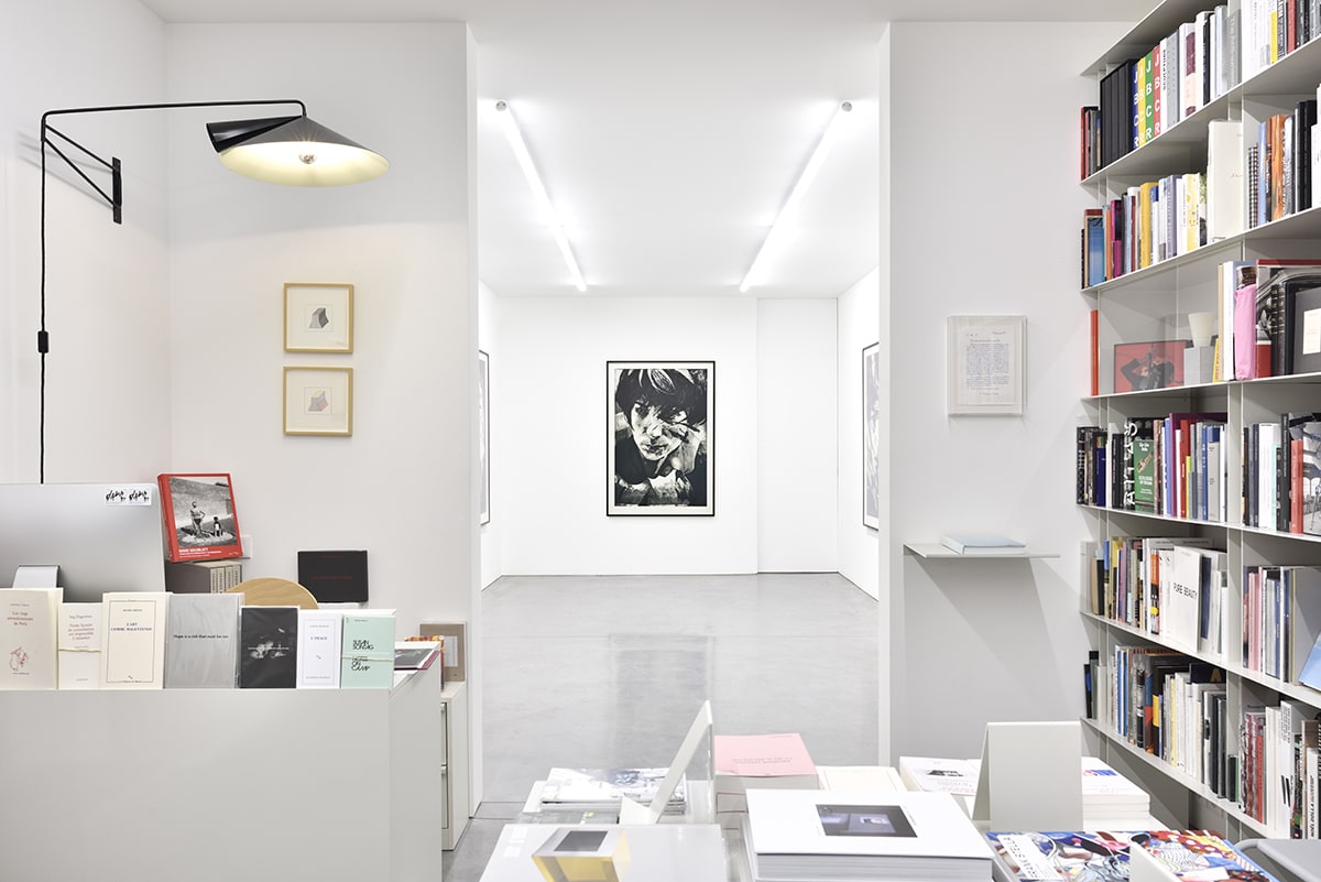 Installation of black and white portrait in a bookshop.