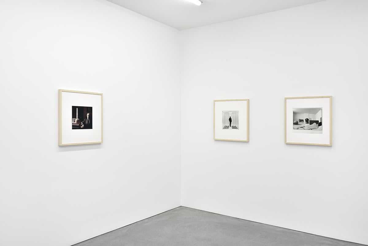 3 framed artworks hang in a gallery.