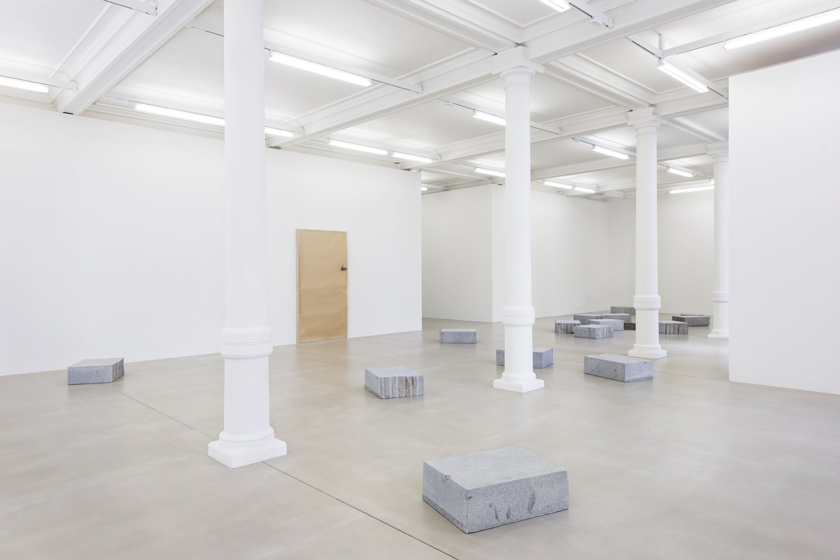 Gallery view, stone blocks arranged in gallery space.