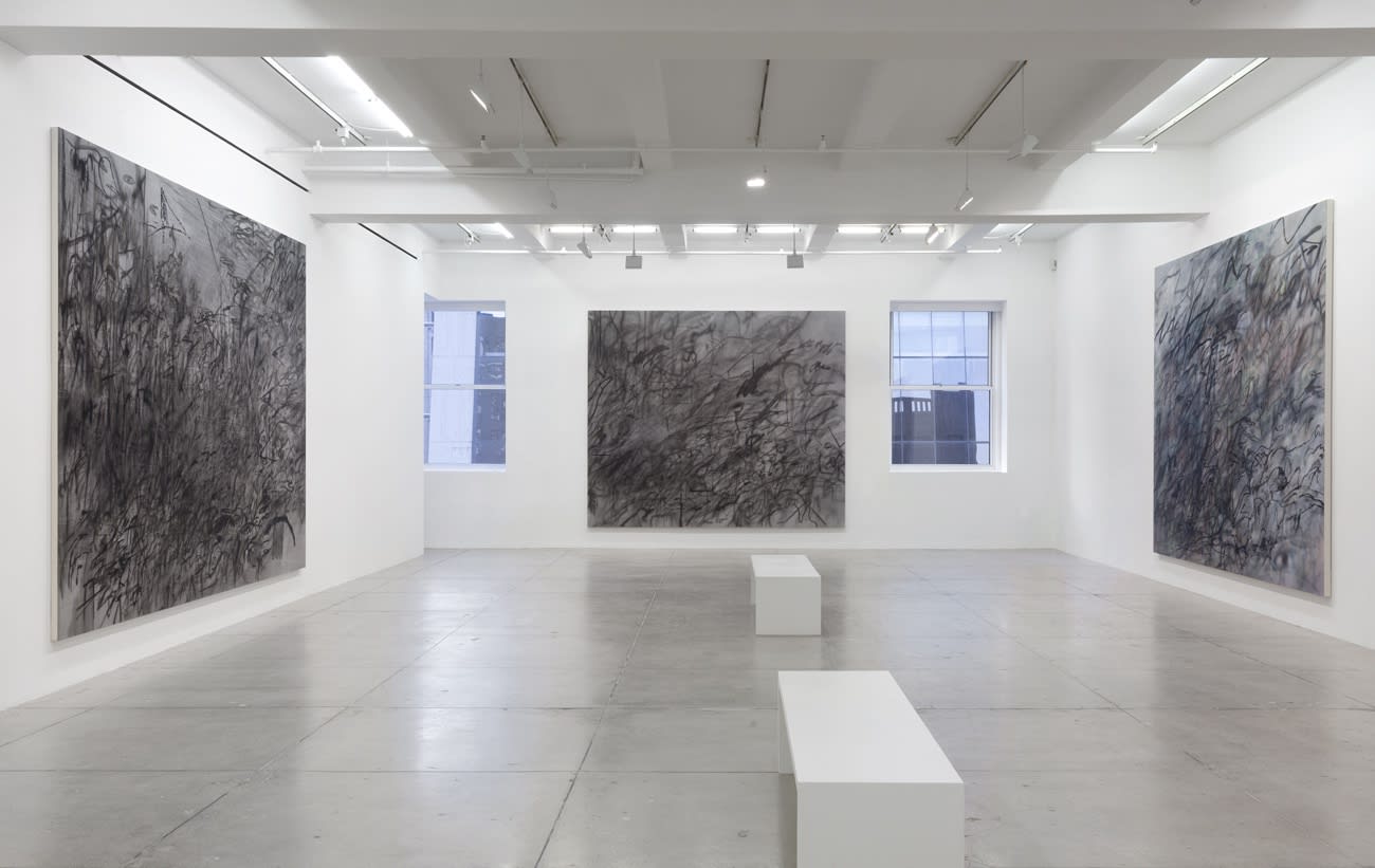 3 abstract paintings hang in a white gallery space with 2 windows and 2 benches.