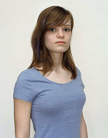 A Rineke Dijkstra portrait of a girl in a blue shirt.